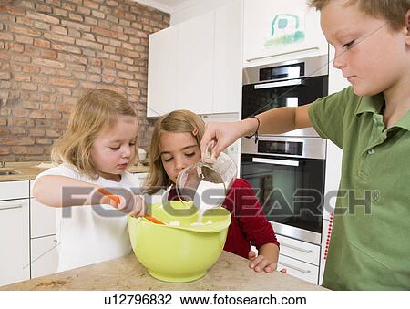 Stock Image - girls and boy mixing ingredients. Fotosearch