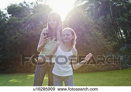 Girls dancing with headphones View Large Photo Image Stock Photo - Girls dancing with headphones. Fotosearch