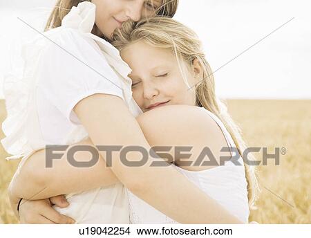 Girls hugging in wheat field View Large Photo Image Picture - Girls hugging in wheat field. Fotosearch