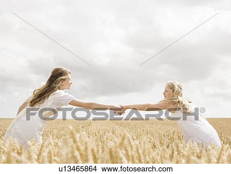 Picture - Girls in wheat field. Fotosearch