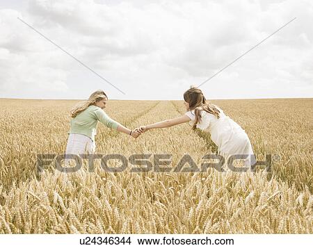 Picture - Girls in wheat Field. Fotosearch