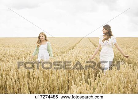 Stock Photography - Girls in wheat Field. Fotosearch