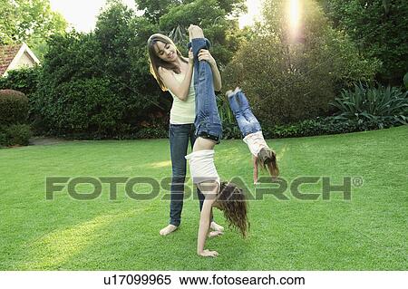 Girls playing in garden View Large Photo Image Stock Photography - Girls playing in garden. Fotosearch