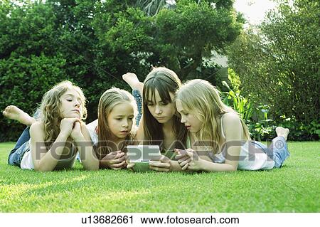 Girls sharing Gameboy View Large Photo Image Stock Image - Girls sharing Gameboy. Fotosearch