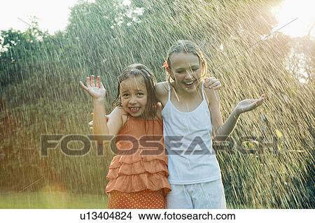 Girls standing in rain View Large Photo Image Picture - Girls standing in rain. Fotosearch