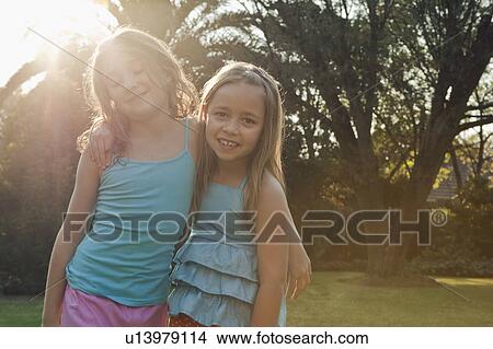 girls with arms around each other View Large Photo Image Picture - girls with arms around each other. Fotosearch