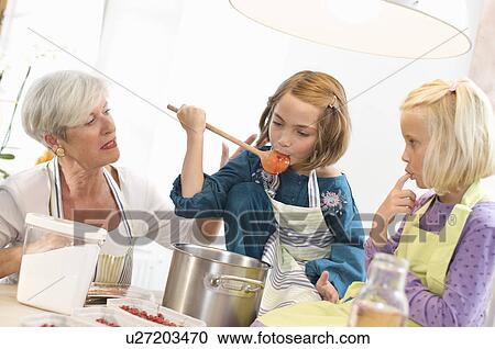 girls with grandmother cooking jam View Large Photo Image Stock Image - girls with grandmother cooking jam. Fotosearch