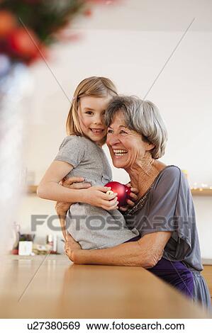 Stock Photo - grandchild and grandma hugging. Fotosearch