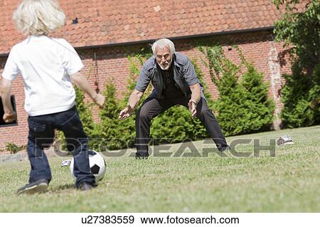 grandfather and child playing football View Large Photo Image Stock Photo - grandfather and child playing football. Fotosearch