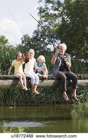 Stock Photo - grandfather and children fishing. Fotosearch