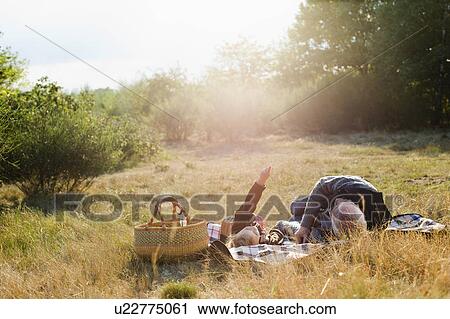 Stock Image - grandfather and granddaughter at picnic. Fotosearch