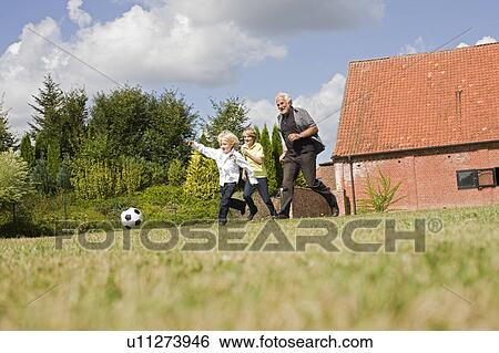grandfather and kids playing football View Large Photo Image Stock Photograph - grandfather and kids playing football. Fotosearch