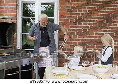 grandfather barbecuing for children View Large Photo Image Stock Image - grandfather barbecuing for children. Fotosearch