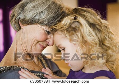 Picture - grandma and grandchild hugging. Fotosearch