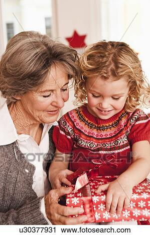 grandma and grandchild opening present View Large Photo Image Stock Image - grandma and grandchild opening present. Fotosearch