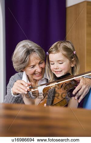 grandma teaching grandchild music View Large Photo Image Picture - grandma teaching grandchild music. Fotosearch