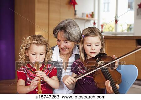 grandma teaching grandchildren music View Large Photo Image Stock Image - grandma teaching grandchildren music. Fotosearch