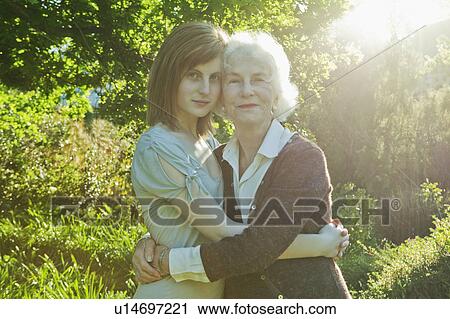 Grandmother and granddaughter hugging View Large Photo Image Stock Image - Grandmother and granddaughter hugging. Fotosearch