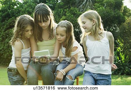 Group of girls playing with Gameboy View Large Photo Image Stock Photograph - Group of girls playing with Gameboy. Fotosearch