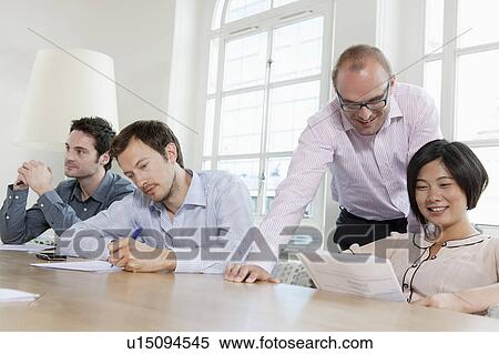 Group of people at a conference table View Large Photo Image Stock Photography - Group of people at a conference table. Fotosearch