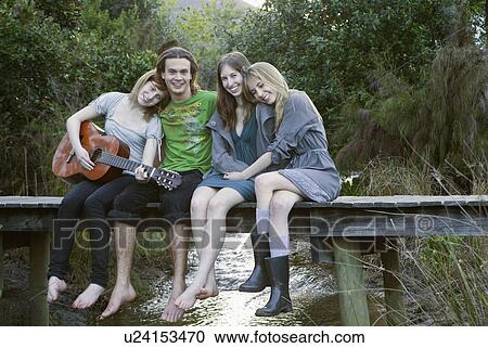 Group on people sitting boardwalk View Large Photo Image Stock Image - Group on people sitting boardwalk. Fotosearch