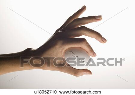 Hand holding egg with hairline crack View Large Photo Image Stock Image - Hand holding egg with hairline crack. Fotosearch