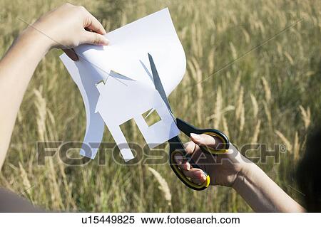 Hands cutting paper house View Large Photo Image Stock Photography - Hands cutting paper house. Fotosearch