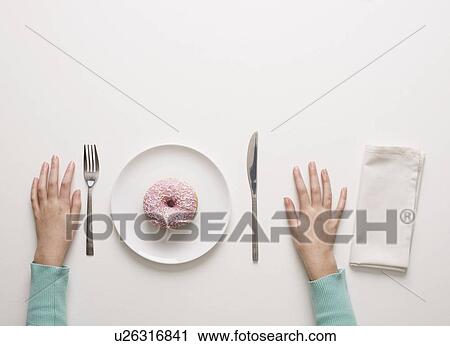 Stock Image - Hands on a table. Fotosearch