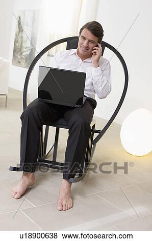 handsome man multitasking View Large Photo Image Stock Photo - handsome man multitasking. Fotosearch