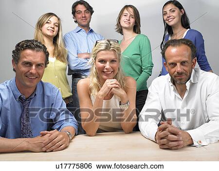 Stock Photograph - Happy coworkers looking at camera. Fotosearch