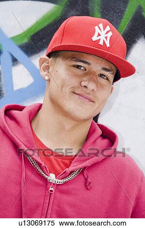 Stock Photography - Hispanic Teenager against graffiti wall. Fotosearch