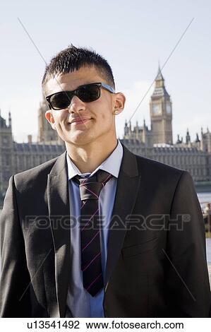 Stock Image - Hispanic Teenager in suit and shades. Fotosearch