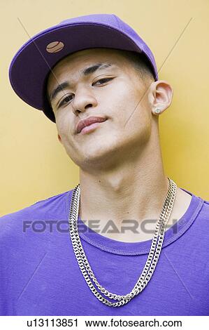 Stock Image - Hispanic Teenager with cap and chain. Fotosearch