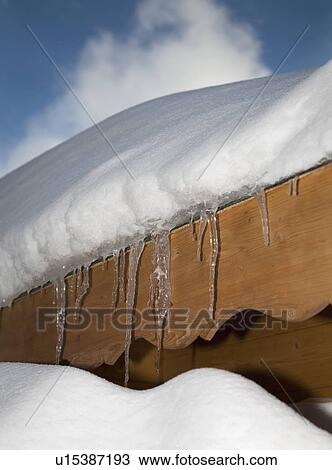 Icicles on snow covered roof View Large Photo Image Stock Image - Icicles on snow covered roof. Fotosearch