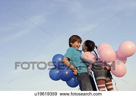 Kids laughing with balloons View Large Photo Image Stock Photo - Kids laughing with balloons. Fotosearch
