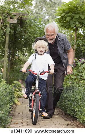 Stock Image - learning to ride a bicycle. Fotosearch