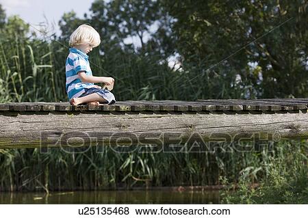 little boy on footbridge View Large Photo Image Stock Photo - little boy on footbridge. Fotosearch