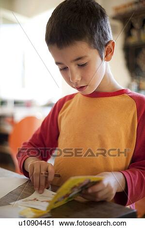 little boy reading, drawing in book View Large Photo Image Stock Image - little boy reading, drawing in book. Fotosearch