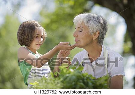 Stock Image - little girl examines something carefully. Fotosearch