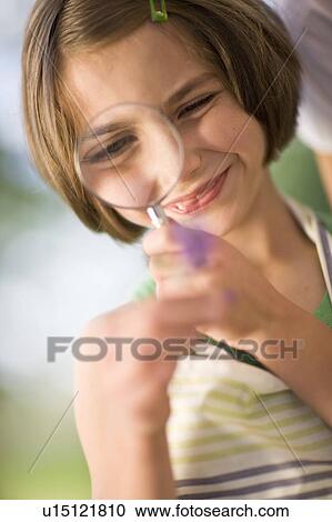 little girl examines something carefully View Large Photo Image Stock Image - little girl examines something carefully. Fotosearch