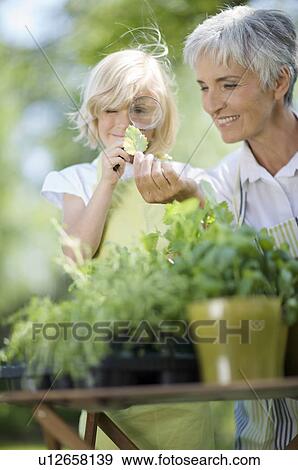 Stock Photo - little girl examines something carefully. Fotosearch