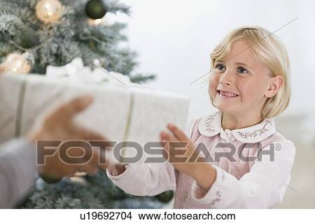 little girl getting a present View Large Photo Image Picture - little girl getting a present. Fotosearch