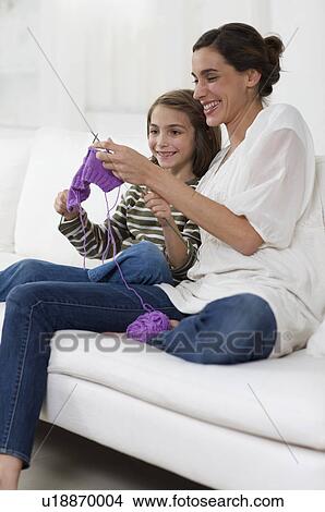 Picture - little girl interested in knitting. Fotosearch