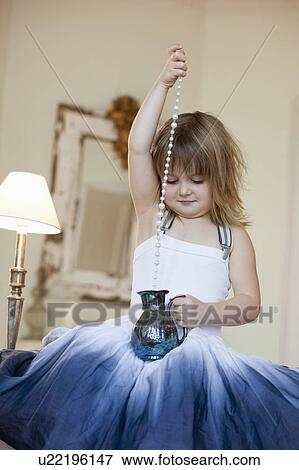 Stock Photo - little girl playing with decoration. Fotosearch