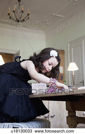 little girl playing with jewelry View Large Photo Image Stock Image - little girl playing with jewelry. Fotosearch