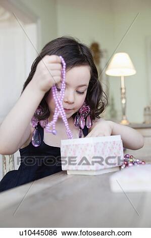 little girl playing with jewelry View Large Photo Image Stock Photograph - little girl playing with jewelry. Fotosearch