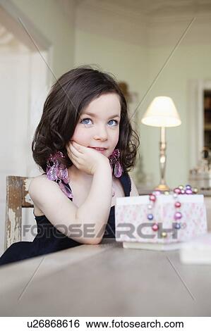 Stock Photograph - little girl posing with jewelry. Fotosearch
