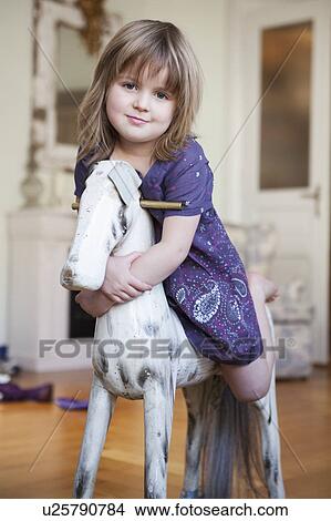 little girl riding rocking horse View Large Photo Image Picture - little girl riding rocking horse. Fotosearch