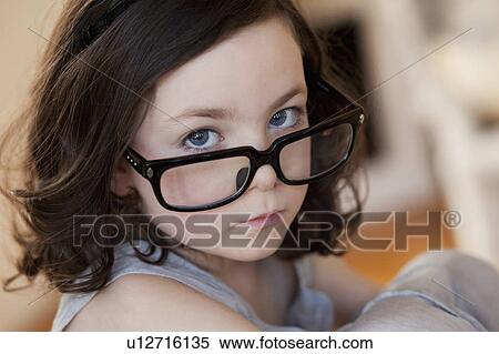 Stock Photography - little girl wearing huge pair of glasses. Fotosearch