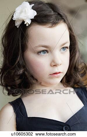 Stock Image - little girl with flower in her hair. Fotosearch